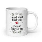White 20 oz Please Forgive Me mug with black lettering, floral details and red heart